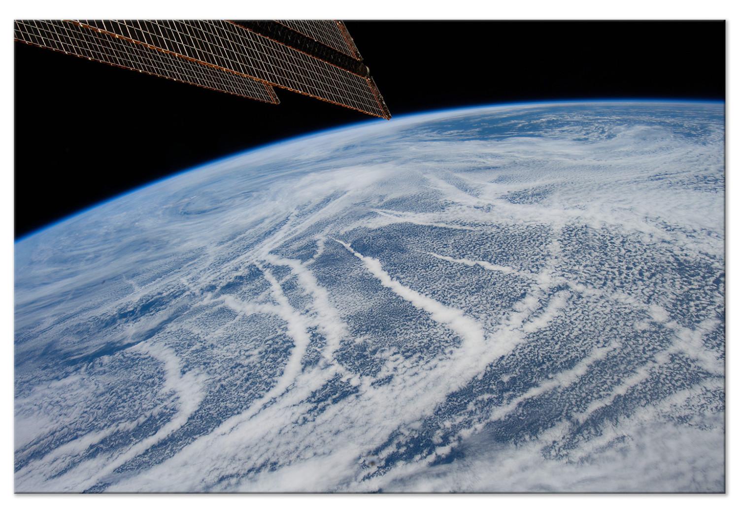 Cuadro decorativo Vuelo espacial - vista satelital de la Tierra y la banda de nubes