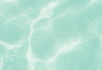 Cuadro Rodajas de pomelo flotando en agua turquesa - abstracción de verano