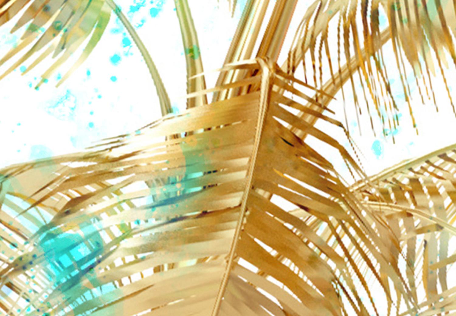 Cuadro Hojas de palmera doradas - paisaje tropical sobre fondo azul