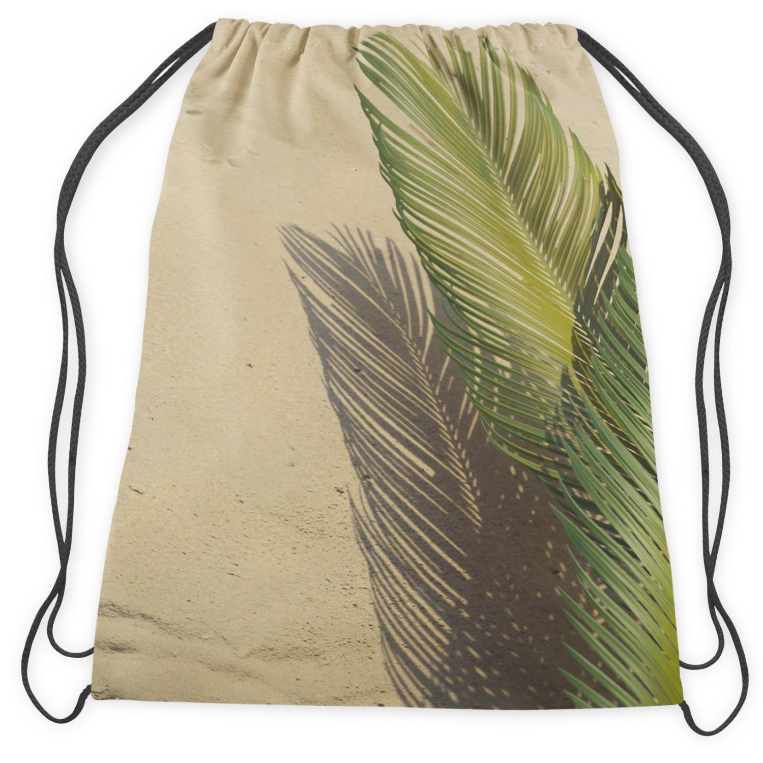 Mochila Palm shade - a minimalist floral composition on a sand background