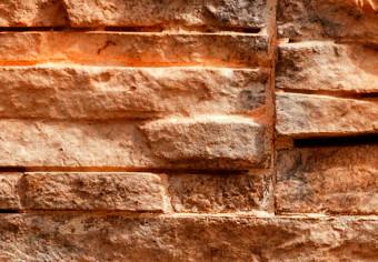 Fotomural decorativo Piedra naranja - fondo con textura irregular de bloques de piedra